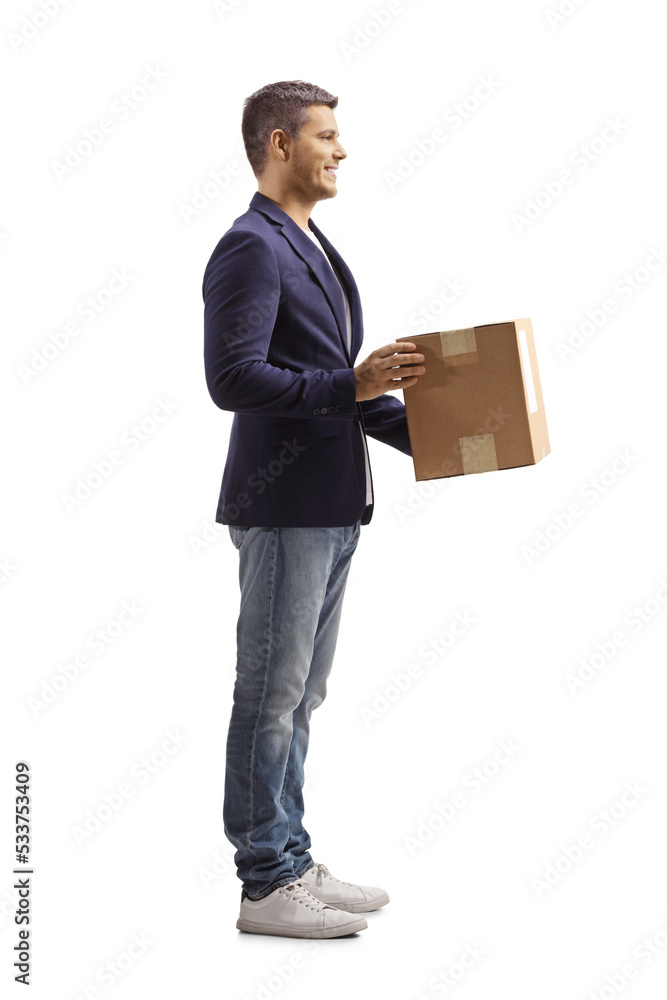 Full length profile shot of a man holding a cardboard box Full length profile shot of a man holding a cardboard box