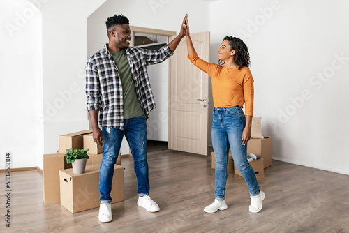 Joyful African American Spouses Giving High Five Celebrating Relocation Indoors