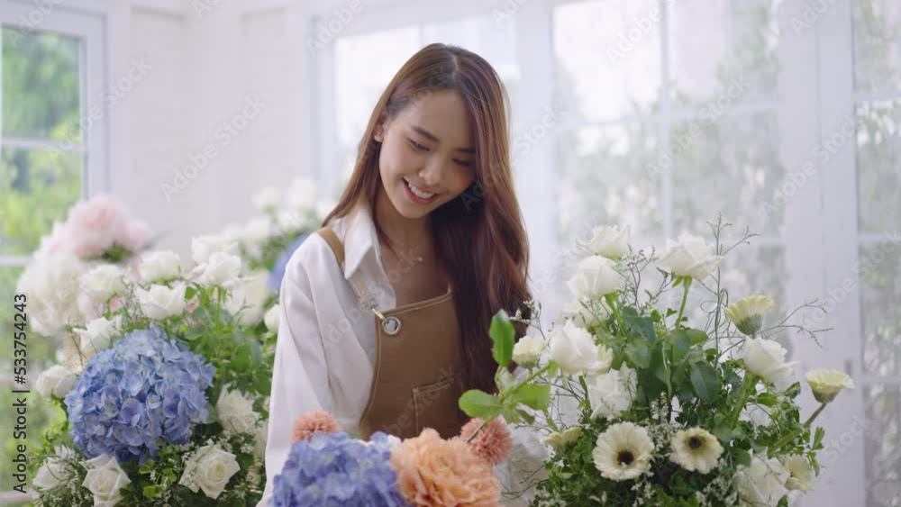 Asian women create lovely floral arrangements to sell. Asian women create lovely floral arrangements to sell.