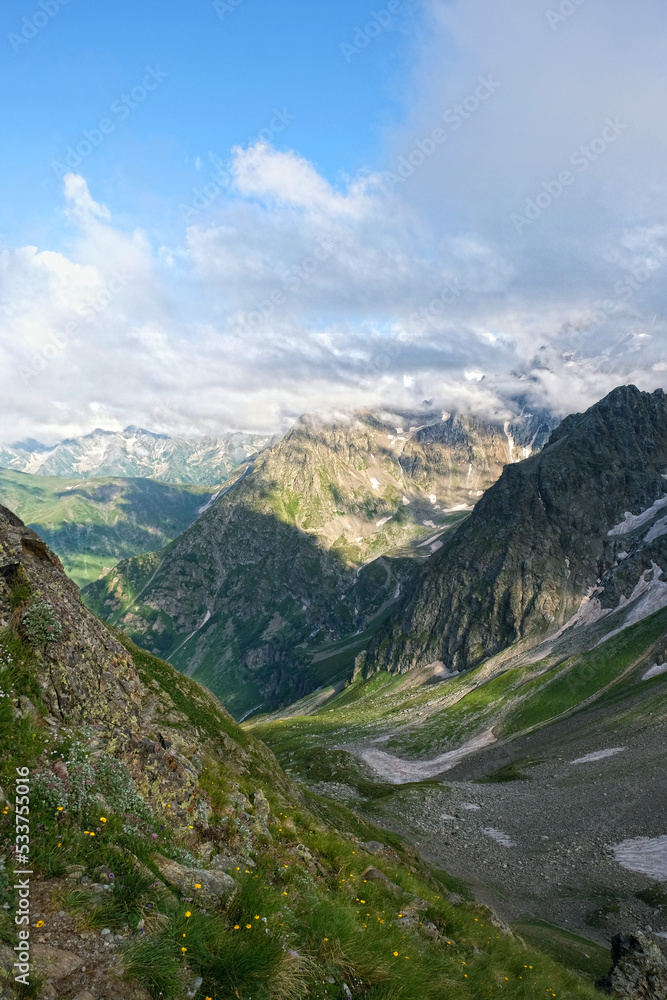 Fototapeta premium Summer landscape with greats mountains against cloudy sky. beautiful scenic nature view with mountains. natural background. trip, journey, hiking, adventure concept. Caucasus mountains, Arkhyz