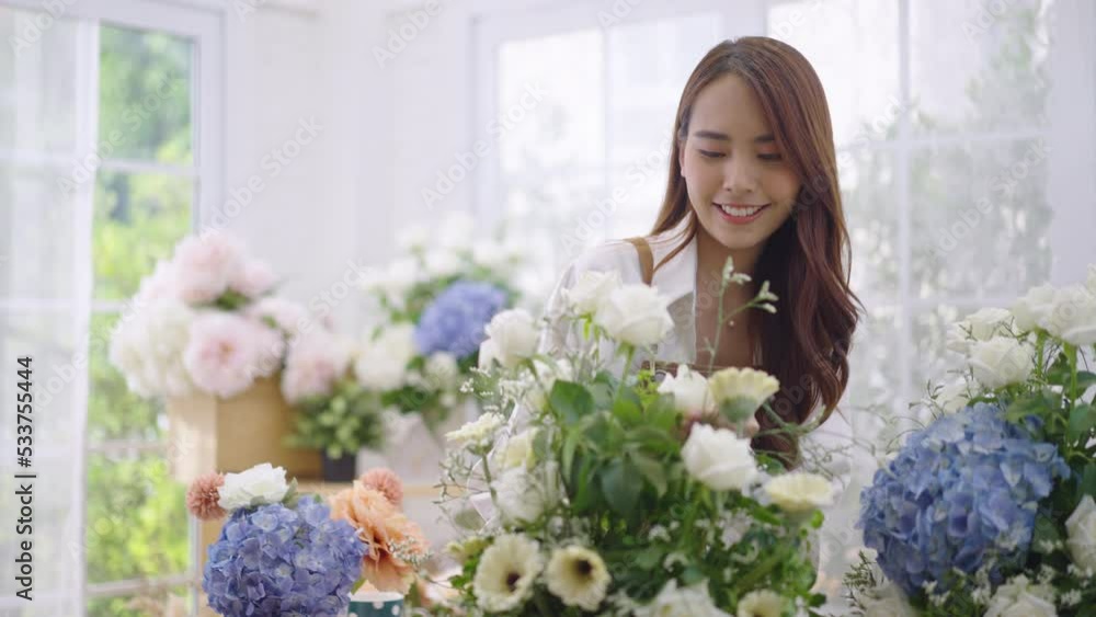 Asian women create lovely floral arrangements to sell. Asian women create lovely floral arrangements to sell.
