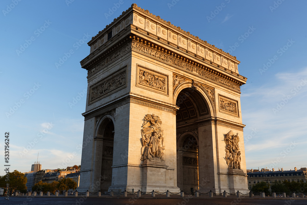 The famous Triumphal Arch at sunny day , Paris, France.