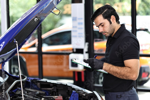 Car mechanic working with a Service checking car engine 