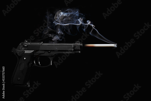 gun firing a cigar in a studio shot on a black background