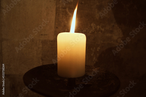 burning candle in the dark light