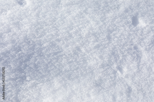 Background of fresh snow texture. Top view of the natural pure snow in winter with copy space.