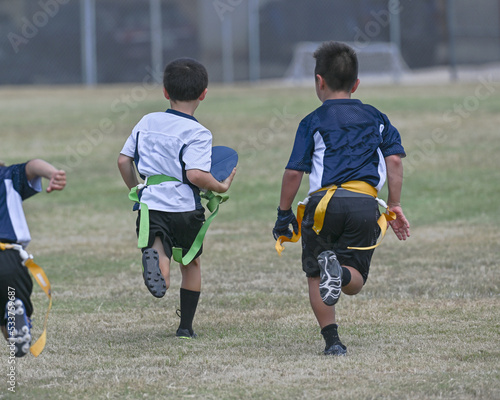 Young boys playing in a game of flag football