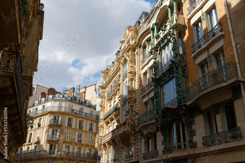 The facades of traditional French houses with typical balconies and windows. Paris. © kovalenkovpetr