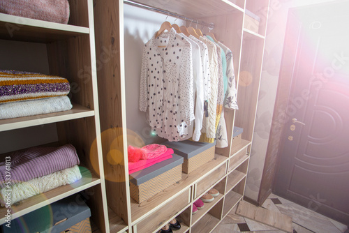 Big wardrobe with different clothes and accessories in dressing room © Smole
