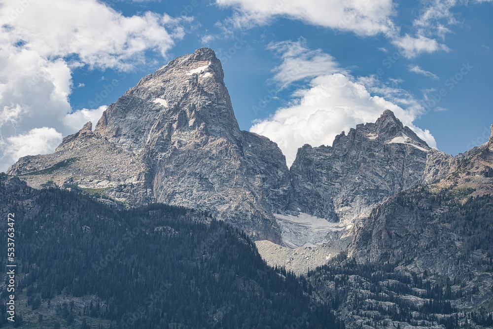 Landscape view of the Grand Teton and Mount Owen peaks with Teton Glacier located in-between. Taken from Teton Glacier Turnout in Grand Teton National Park.