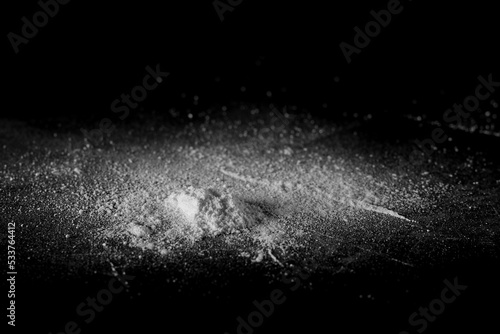 Cocaine powder isolated on black, side view 