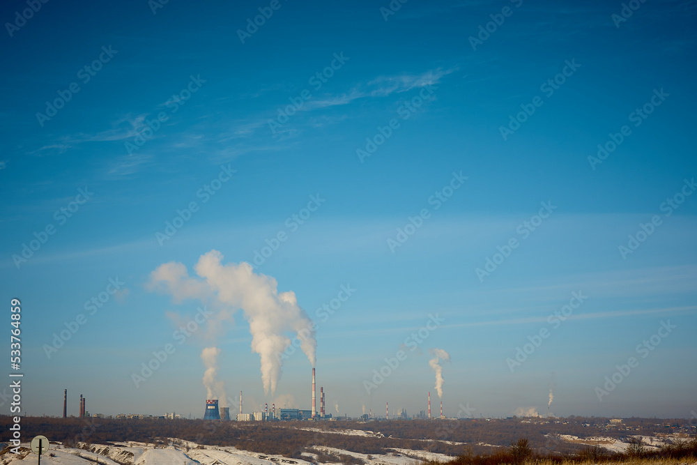 smoke from a pipe plant against a blue sky. Pollution of the environment, environmental problems