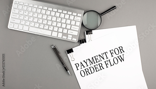 Photography PAYMENT FOR ORDER FLOW text on paper with keyboard, magnifier and pen