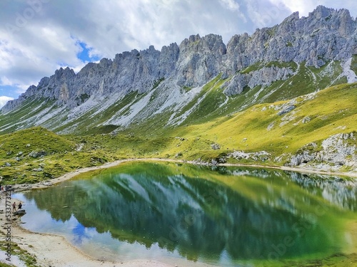 Reflection of the Mount Cresta del Ferro in the Lake Olbe on a cloudy day in Sappada on the Dolomites photo