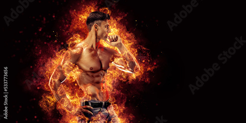 Bodybuilder posing on the fire flames background