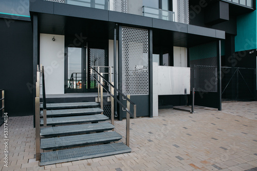 modern front door porch at the entrance and a lift for disabled people