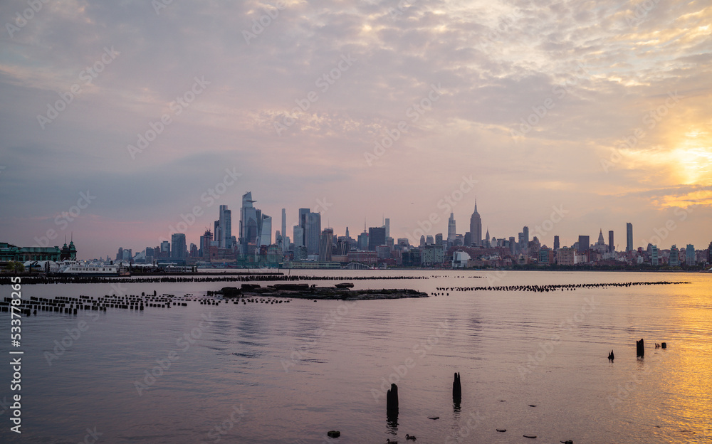 Fototapeta premium New York Manhattan skyline at sunset reflection river 