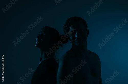 silhouette of a couple. Romantic lovers. Couple in love. Shadow. Neon light background. Man and woman. 