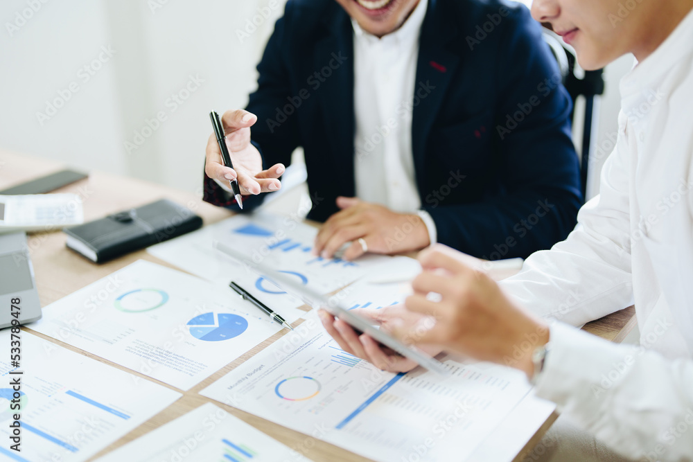 Fototapeta premium Concept of the impact of warring countries, male economists are using tablets to consult with marketing staff or accountants to adjust production and investment strategies to the current situation.