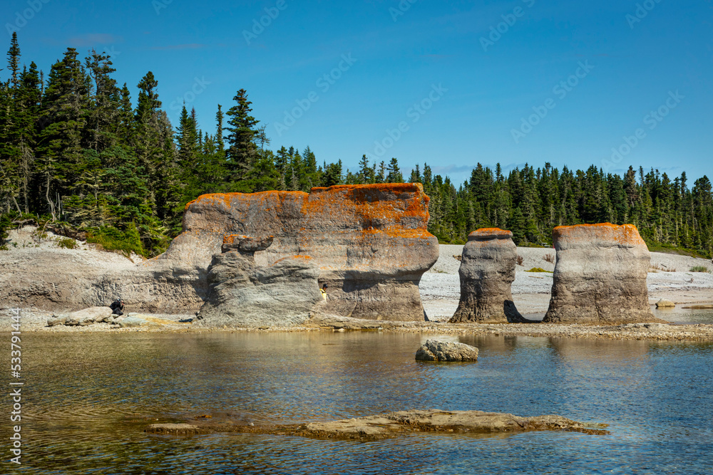 Obraz premium Monoliths under a beautiful blue sky in Mingan Archipelago National Park Reserve of Canada, Quebec, Canada