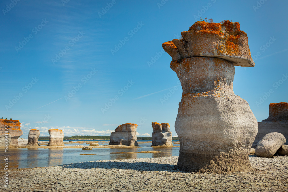 Fototapeta premium Monoliths under a beautiful blue sky in Mingan Archipelago National Park Reserve of Canada, Quebec, Canada
