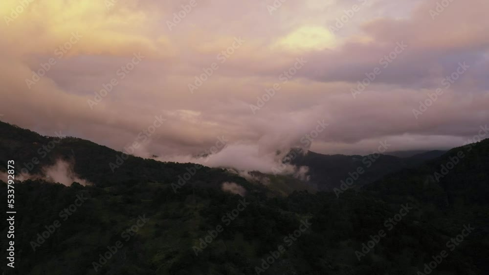 Mountain peaks in the clouds during sunset. Hills in mountain valley during sunset. Natural summer mountain landscape. Cordillera on Luzon Island, Philippines, aerial view. Mountain peaks in the clouds during sunset. Hills in mountain valley during sunset. Natural summer mountain landscape. Cordillera on Luzon Island, Philippines, aerial view.