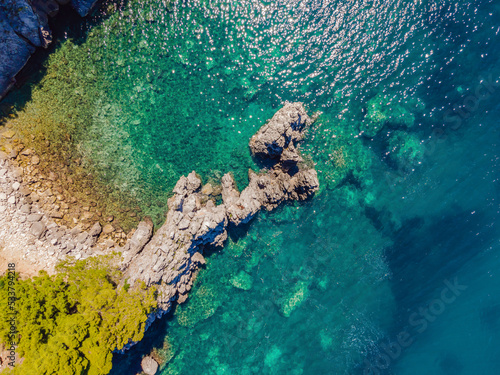 Picturesque sea Adriatic coast of Montenegro. Turquoise Mediteran sea and rocky shore with evergreen coniferous trees. Wonderful summer landscape. Drone © galitskaya