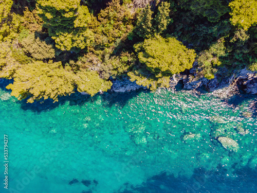 Fototapeta Naklejka Na Ścianę i Meble -  Picturesque sea Adriatic coast of Montenegro. Turquoise Mediteran sea and rocky shore with evergreen coniferous trees. Wonderful summer landscape. Drone