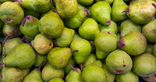 stack of pears on the supermarket shelf
