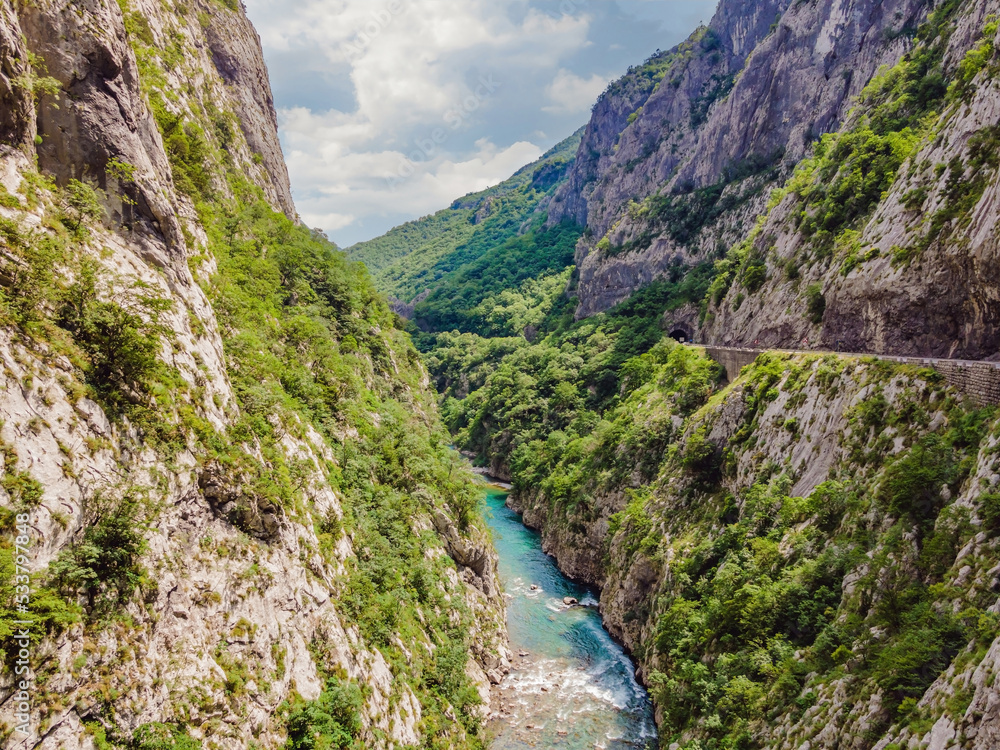 The purest waters of the turquoise color of the river Moraca flowing among the canyons. Travel around Montenegro concept Portrait of a disgruntled girl sitting at a cafe table