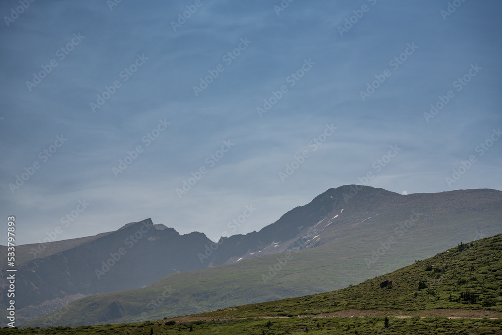 Thin Clouds Highlight The Sky Over Bierstadt Mountain