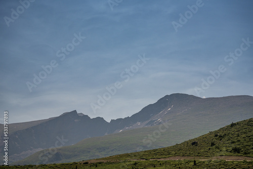 Thin Clouds Highlight The Sky Over Bierstadt Mountain