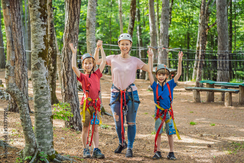 Friends on the ropes course. Young people in safety equipment are obstacles on the road rope Portrait of a disgruntled girl sitting at a cafe table