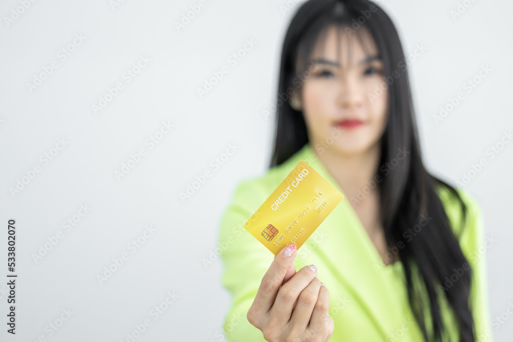 Asian woman holding credit card on white background, Asian woman showing presenting credit card, Woman holding bank business credit card with copy space. Asian woman holding credit card on white background, Asian woman showing presenting credit card, Woman holding bank business credit card with copy space.