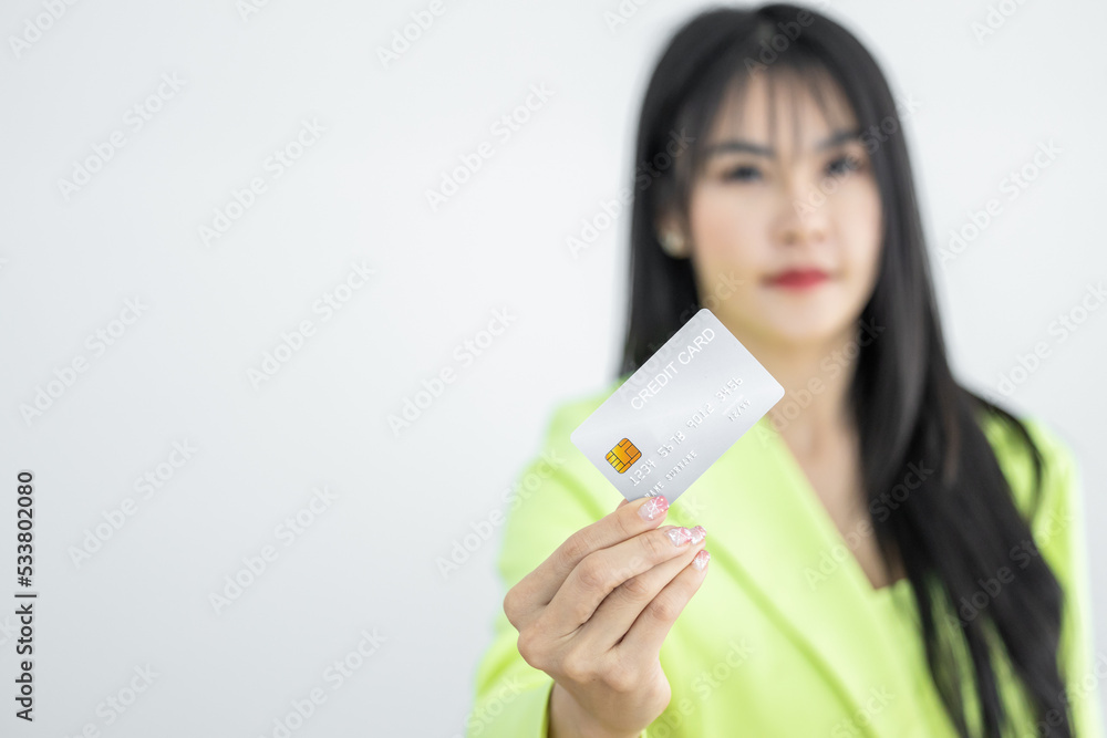 Asian woman holding credit card on white background, Asian woman showing presenting credit card, Woman holding bank business credit card with copy space. Asian woman holding credit card on white background, Asian woman showing presenting credit card, Woman holding bank business credit card with copy space.