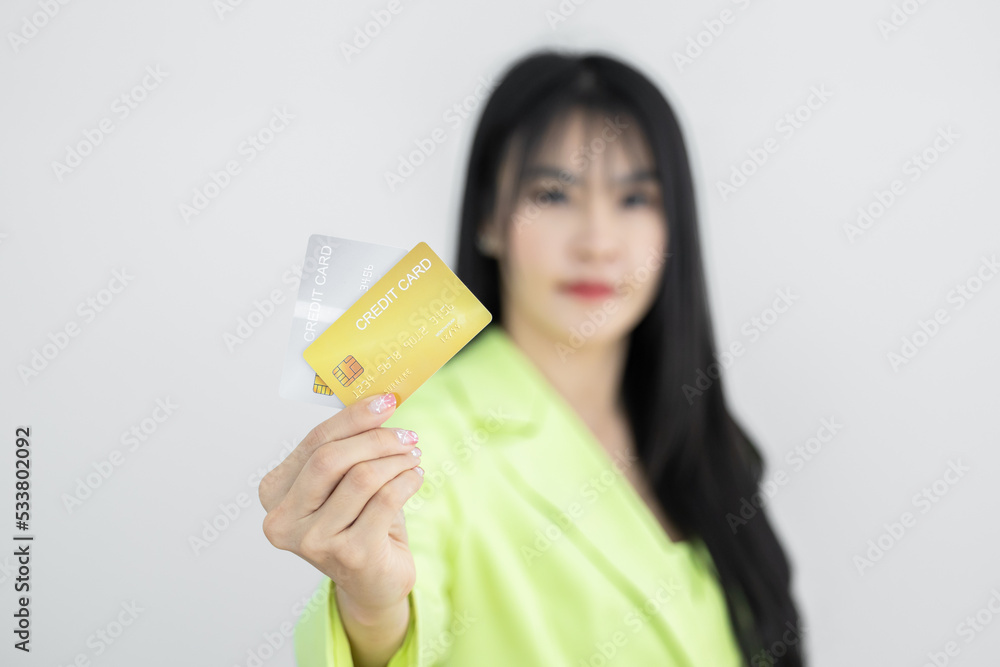Asian woman holding credit card on white background, Asian woman showing presenting credit card, Woman holding bank business credit card with copy space. Asian woman holding credit card on white background, Asian woman showing presenting credit card, Woman holding bank business credit card with copy space.