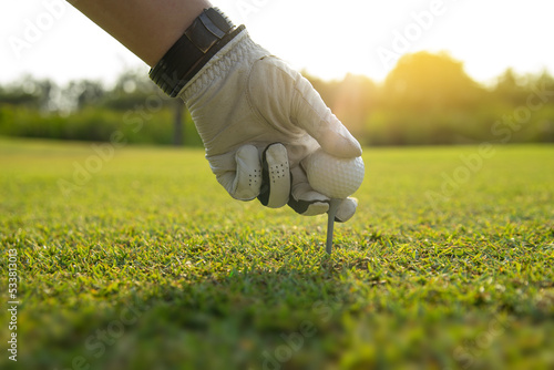 golfer prepare tee off on grass course for driver a ball into the hole in the morning time