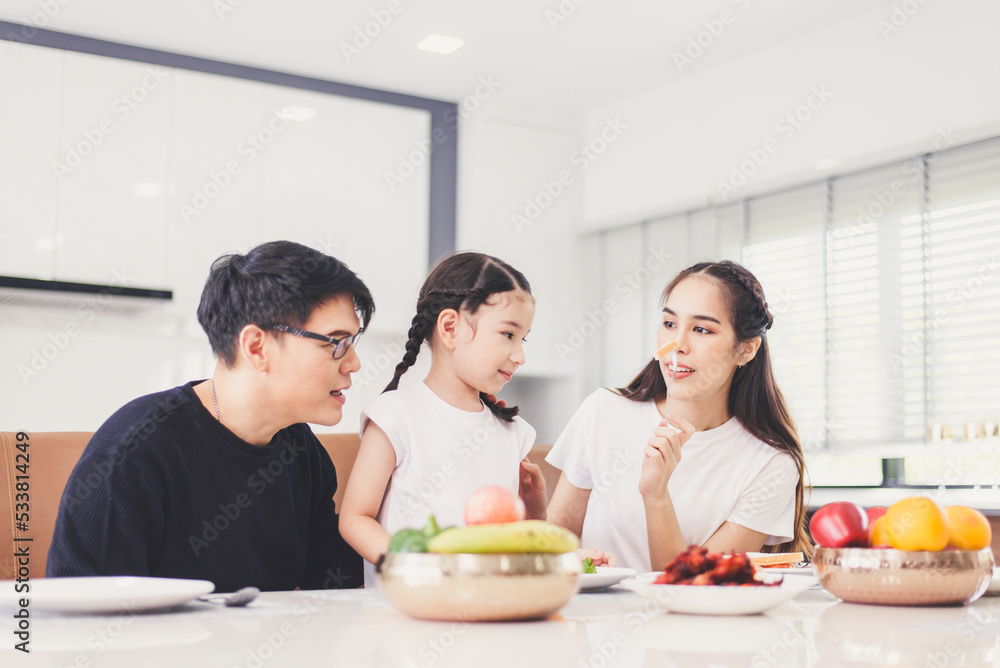 Happy asian family and having fun during eating meal together at home Happy asian family and having fun during eating meal together at home
