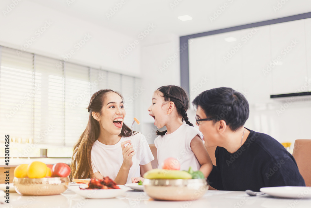 Happy asian family and having fun during eating meal together at home Happy asian family and having fun during eating meal together at home