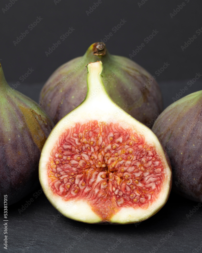 Figs cut into pieces on a black background close-up