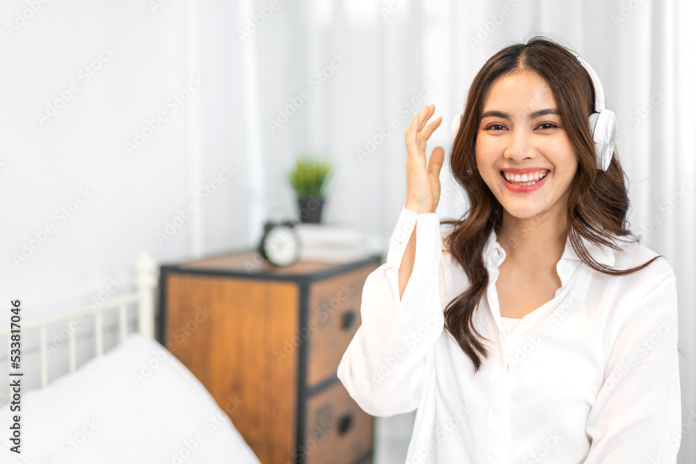 Portrait of smiling cheerful beautiful pretty asian woman clean fresh healthy white skin posing smile in pajamas white clothes.Girl felling relax and enjoy time on the bed at home.asia beauty Portrait of smiling cheerful beautiful pretty asian woman clean fresh healthy white skin posing smile in pajamas white clothes.Girl felling relax and enjoy time on the bed at home.asia beauty