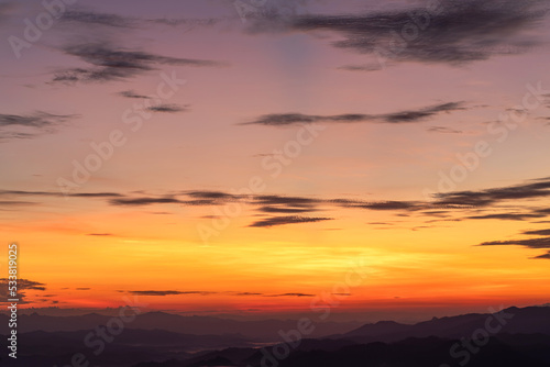 Sunset or sunrise mountain peaks colorful sky. Colorful Sky At Sunset Dawn Sunrise. Sun Over Skyline  Horizon. Warm Colours.