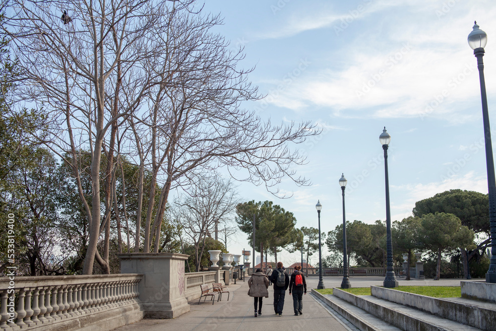 wide shot of Tourist walking through park in barcelona spain