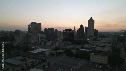 Drone Flying during Sunset around Buildings in Downtown Memphis, Tennessee with the Mississippi River Bridge in the background.