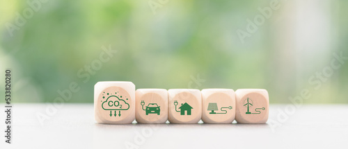Industrial emissions pollute the environment and ecosystems. including climate change Carbon Renewable Energy Agreement reduce greenhouse gas emissions ,icon and wooden blocks on table