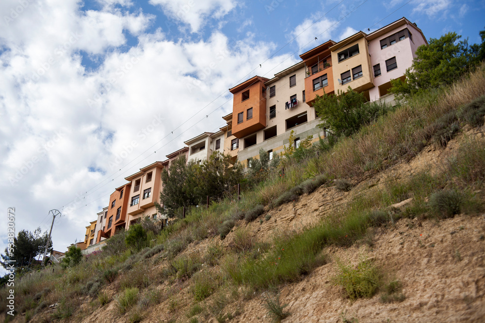 Fototapeta premium orange and yellow houses on mountain a hilltop