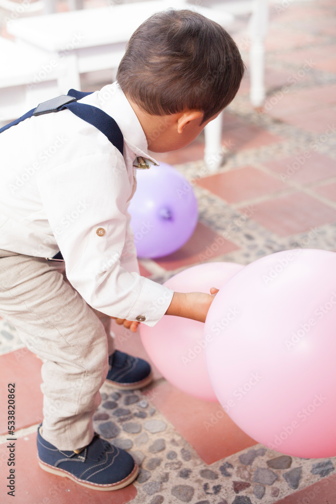 dressed up toddler with balloon playing in the backyard dressed up toddler with balloon playing in the backyard