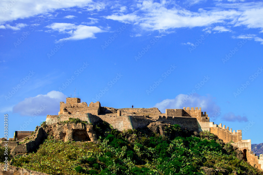 castle of sagunt in spain with port city and ocean background