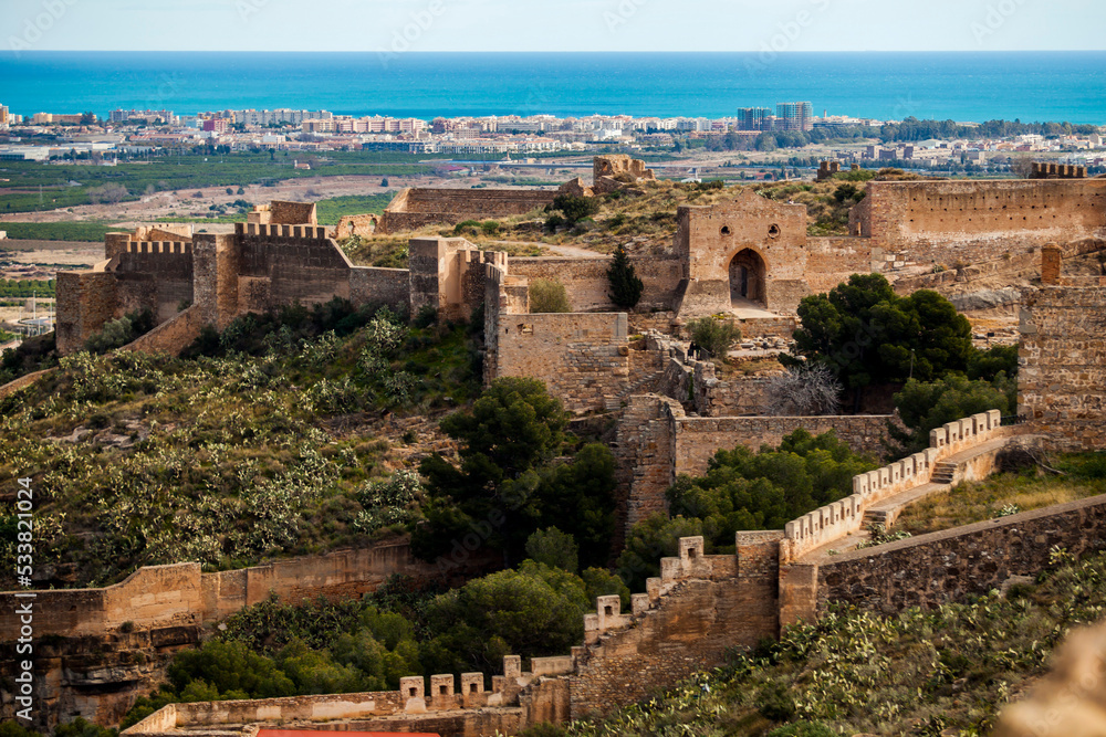 castle of sagunt in spain with port city and ocean background - obrazy, fototapety, plakaty 