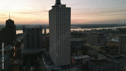 Drone Flying during Sunset around Buildings in Downtown Memphis, Tennessee with the Mississippi River Bridge in the background.